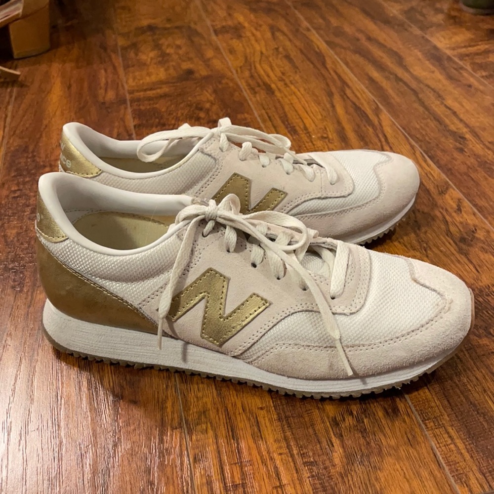 Gold snd white new balance sneakers